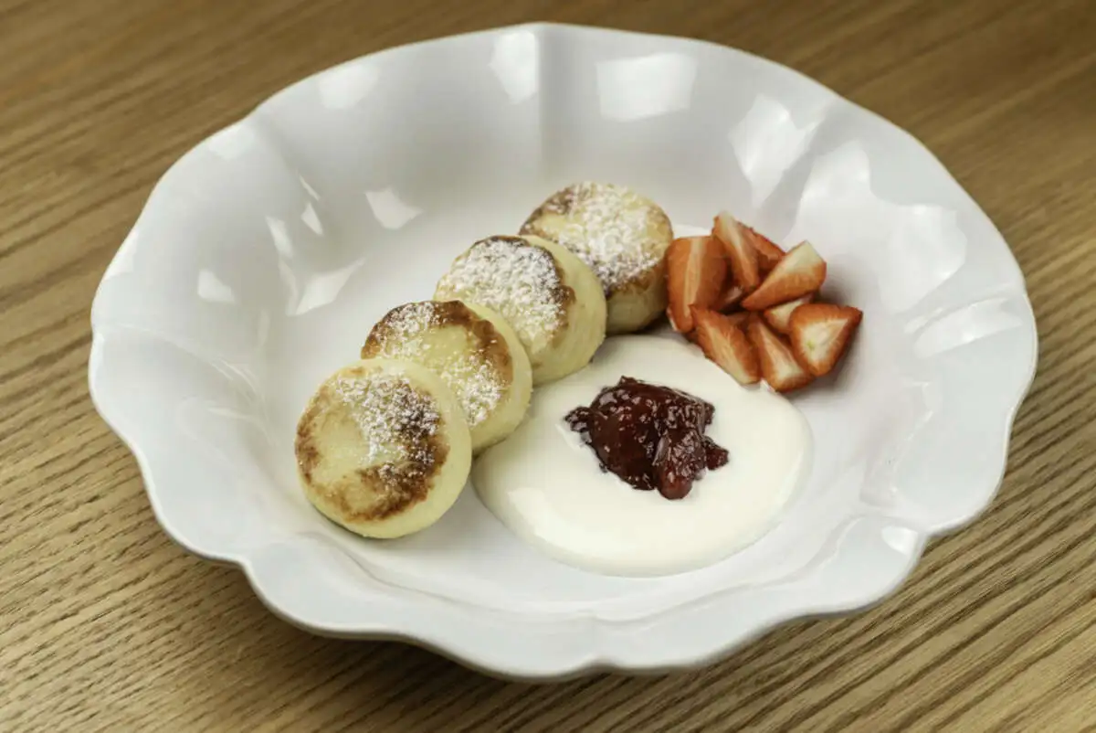 Сырники из рикотты с джемом и взбитой сметаной 