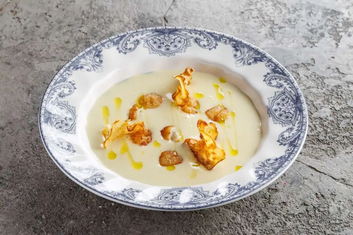 Картофельный суп с гребешком, трюфельным маслом и чипсами из сельдерея